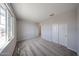 Bright, carpeted bedroom with closet, window, and neutral walls at 18236 W Daley Ln, Surprise, AZ 85387