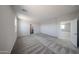 Expansive bedroom with soft carpeting, neutral walls, and entry to bathroom at 18236 W Daley Ln, Surprise, AZ 85387