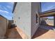 Exterior view of the home's side with windows, covered patio, and the yard, blending indoor/outdoor living at 18236 W Daley Ln, Surprise, AZ 85387