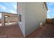Side view of house showcasing architectural details, windows, covered patio, and exterior facade at 18236 W Daley Ln, Surprise, AZ 85387