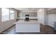 Well-designed kitchen with a large island, granite countertops, and stainless steel appliances at 18236 W Daley Ln, Surprise, AZ 85387