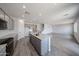 Open concept kitchen with an island, gray cabinets, granite countertops, and tile flooring at 18236 W Daley Ln, Surprise, AZ 85387