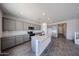 Bright kitchen featuring gray cabinets, granite countertops, and stainless steel appliances at 18236 W Daley Ln, Surprise, AZ 85387