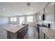 Bright, spacious kitchen with an island, stainless appliances, and sleek countertops at 18236 W Daley Ln, Surprise, AZ 85387