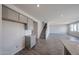 Kitchenette area featuring granite counters, gray cabinets, and views into the living room at 18236 W Daley Ln, Surprise, AZ 85387