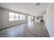 Open-concept living room showcases neutral colors, tile flooring, and a seamless transition to the modern kitchen at 18236 W Daley Ln, Surprise, AZ 85387