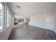 Bright living room with tile flooring flows into the kitchen, providing an open and airy living space at 18236 W Daley Ln, Surprise, AZ 85387