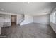 Inviting living room featuring an open concept with access to the kitchen, stairs, and lots of natural light at 18236 W Daley Ln, Surprise, AZ 85387