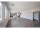 Spacious living area featuring tile flooring, access to the kitchen, and a neutral color palette at 18236 W Daley Ln, Surprise, AZ 85387