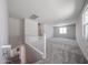 Loft area with soft carpet, natural light from the windows, and a view of the staircase at 18236 W Daley Ln, Surprise, AZ 85387
