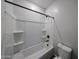 A clean tub and shower combination with white walls and black hardware at 18236 W Daley Ln, Surprise, AZ 85387