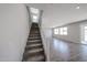 Carpeted staircase with white railing leading to the upper level of the home, with access to the living area at 18236 W Daley Ln, Surprise, AZ 85387