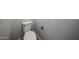 Close up of toilet with black metal toilet paper holder and textured wall at 18236 W Daley Ln, Surprise, AZ 85387