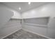 Walk-in closet featuring carpeted flooring and built-in shelving for ample storage at 18236 W Daley Ln, Surprise, AZ 85387