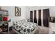 Comfortable bedroom featuring leafy-patterned bedding, modern decor, and natural light at 2040 S Longmore -- # 9, Mesa, AZ 85202