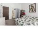 Well-lit bedroom with a queen-sized bed, art decor and a shelf for storage at 2040 S Longmore -- # 9, Mesa, AZ 85202