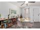 Dining area with a white table, pink chairs and a wooden bookshelf with decorative items at 2040 S Longmore -- # 9, Mesa, AZ 85202