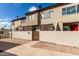View of the tan exterior of a multi-unit dwelling featuring a private gated patio at 2040 S Longmore -- # 9, Mesa, AZ 85202