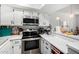 Modern white kitchen featuring stainless steel appliances and a built-in microwave at 2040 S Longmore -- # 9, Mesa, AZ 85202