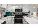 Well-lit kitchen with stainless steel appliances and white cabinetry at 2040 S Longmore -- # 9, Mesa, AZ 85202