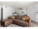 Open concept living room with view into kitchen, featuring modern ceiling fan and decor at 2040 S Longmore -- # 9, Mesa, AZ 85202