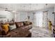 Comfortable living room with hardwood floors, a ceiling fan, and a large brown leather couch at 2040 S Longmore -- # 9, Mesa, AZ 85202