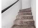 Carpeted staircase with a dark railing and white walls leading to the upper level at 2040 S Longmore -- # 9, Mesa, AZ 85202