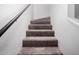 Carpeted staircase with a dark railing and white walls leading to the upper level at 2040 S Longmore -- # 9, Mesa, AZ 85202