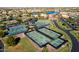 Aerial view showcasing multiple tennis courts and a picturesque community in a well-planned layout at 21093 N Willow Rd, Maricopa, AZ 85138