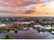 Aerial community view featuring a lake, pool, and beautiful sunset at 21093 N Willow Rd, Maricopa, AZ 85138