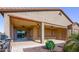 Covered back patio with ceiling fans, paver flooring, and desert landscaping at 21093 N Willow Rd, Maricopa, AZ 85138
