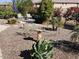 Landscaped backyard with gravel, greenery, a bird bath, and comfortable seating for relaxing at 21093 N Willow Rd, Maricopa, AZ 85138