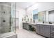 Modern bathroom with dual sink vanity, granite countertops, and walk-in shower at 21093 N Willow Rd, Maricopa, AZ 85138