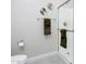 Bright white bathroom featuring a glass enclosed shower, toilet, and neutral walls with decorative touches at 21093 N Willow Rd, Maricopa, AZ 85138