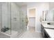 Contemporary bathroom showcasing a glass shower and walk-in closet entrance at 21093 N Willow Rd, Maricopa, AZ 85138