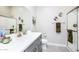 Bright bathroom with a white double sink vanity, neutral walls and a glass enclosed walk-in shower at 21093 N Willow Rd, Maricopa, AZ 85138