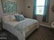 Comfortable bedroom with a bed, side tables, decor, and a window at 21093 N Willow Rd, Maricopa, AZ 85138