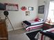 Shared bedroom with two twin beds, sports memorabilia and decorations at 21093 N Willow Rd, Maricopa, AZ 85138