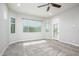 Bedroom with neutral walls, carpet flooring, large windows with blinds and a glass panel door to the exterior at 21093 N Willow Rd, Maricopa, AZ 85138