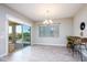 Bright dining room with hard floors, a chandelier, and a sliding glass door leading to a patio at 21093 N Willow Rd, Maricopa, AZ 85138