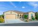 Charming single-story home featuring a low-maintenance front yard and a two-car garage at 21093 N Willow Rd, Maricopa, AZ 85138