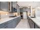 Modern kitchen featuring stainless steel appliances, gray cabinetry, granite countertops, and stylish backsplash at 21093 N Willow Rd, Maricopa, AZ 85138