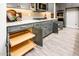 Gourmet kitchen featuring granite countertops, stainless steel appliances, and gray cabinets with pull-out shelving at 21093 N Willow Rd, Maricopa, AZ 85138