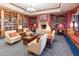 Beautiful library with large bookshelves, a fireplace, seating, and plenty of natural light at 21093 N Willow Rd, Maricopa, AZ 85138
