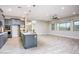 Open-concept kitchen and living space with hard floors and an island with bar seating at 21093 N Willow Rd, Maricopa, AZ 85138