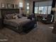 Spacious main bedroom with large windows, plush carpeting, and elegant furnishings at 21093 N Willow Rd, Maricopa, AZ 85138