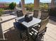 Outdoor patio featuring a dining table and chairs, with bench seating and views of the landscaped yard at 21093 N Willow Rd, Maricopa, AZ 85138