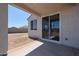 Covered back patio with large sliding glass doors entering into the home at 22035 N Rummler Ln, Maricopa, AZ 85138