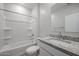 Well-lit bathroom featuring a tub-shower combo, a vanity with a sink, and a granite countertop at 22035 N Rummler Ln, Maricopa, AZ 85138
