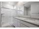 Bathroom with granite countertops, double sinks, and an enclosed glass door shower at 22035 N Rummler Ln, Maricopa, AZ 85138
